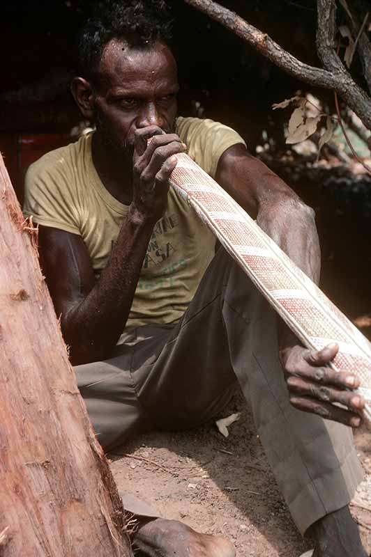 Playing a didjeridu