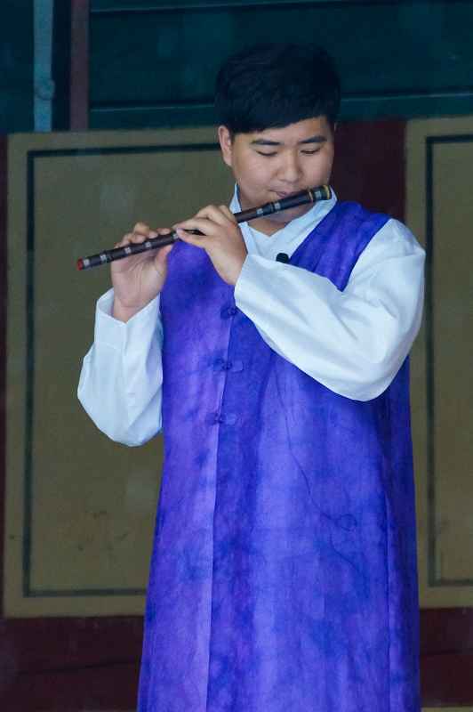 Playing a bamboo flute