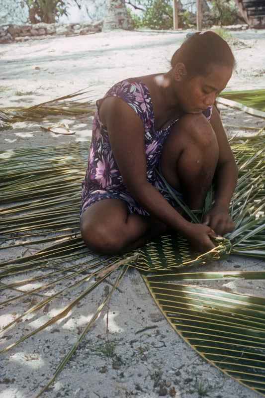 Margarina weaving a mat