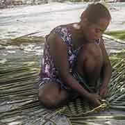 Margarina weaving a mat