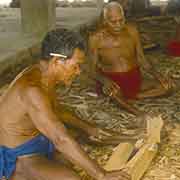 Carving the prow of a canoe