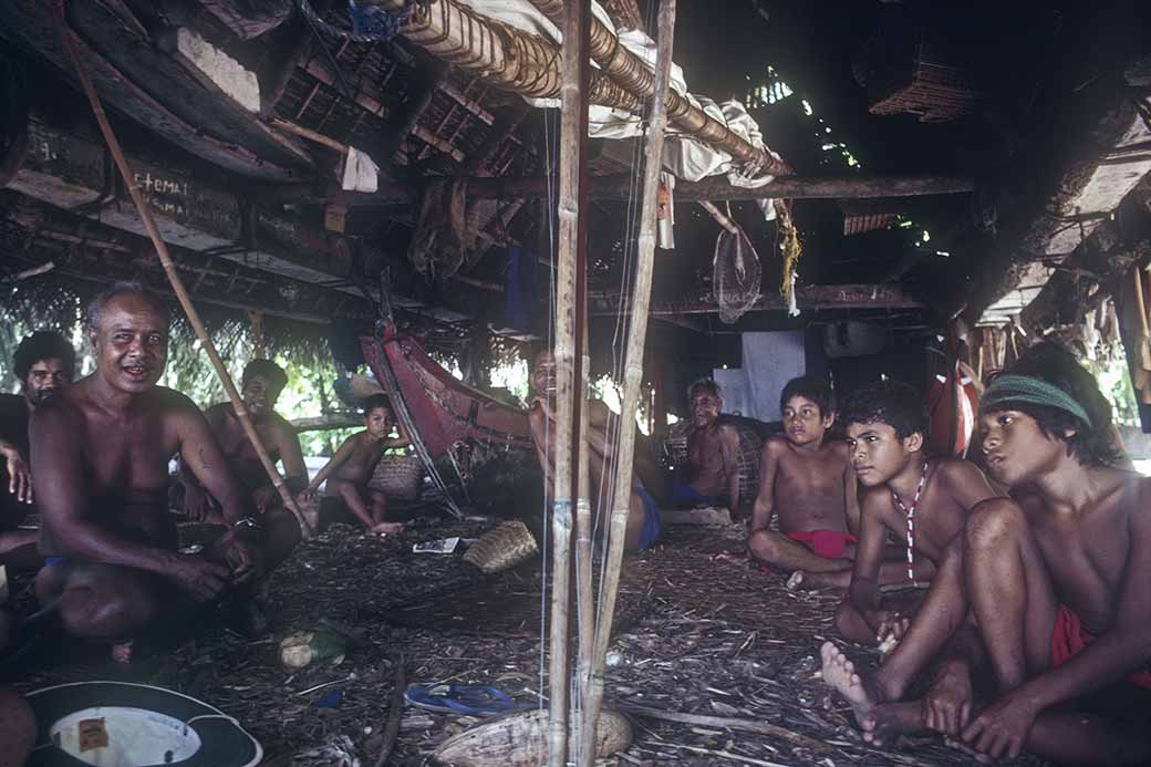 Men and boys in canoe house