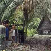 Putting copra in bags, Woleai