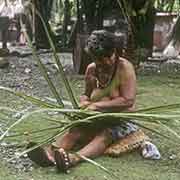 Woman weaving pandanus mat