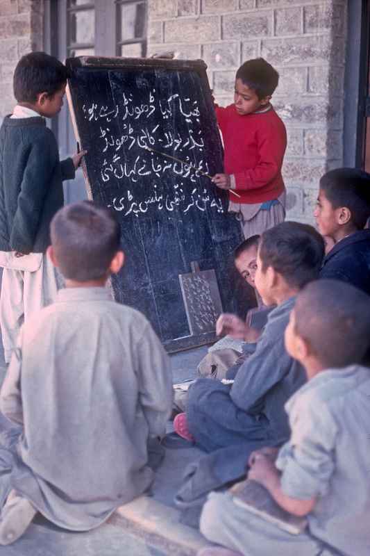 Two boys reading Urdu