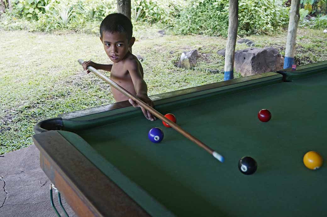 Boy playing pool