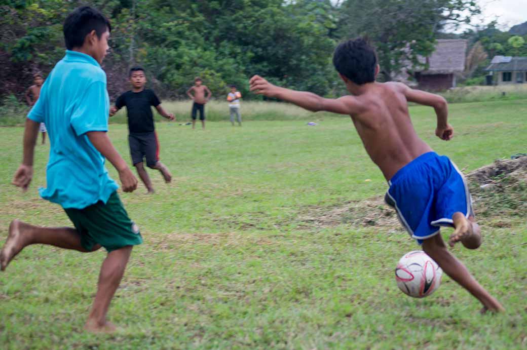 Boys playing football, Palumeu