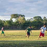 Men playing football, Palumeu