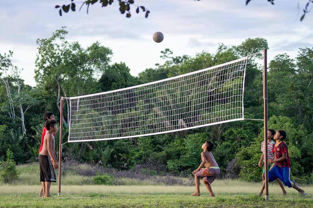 Boys playing volleyball, Palumeu