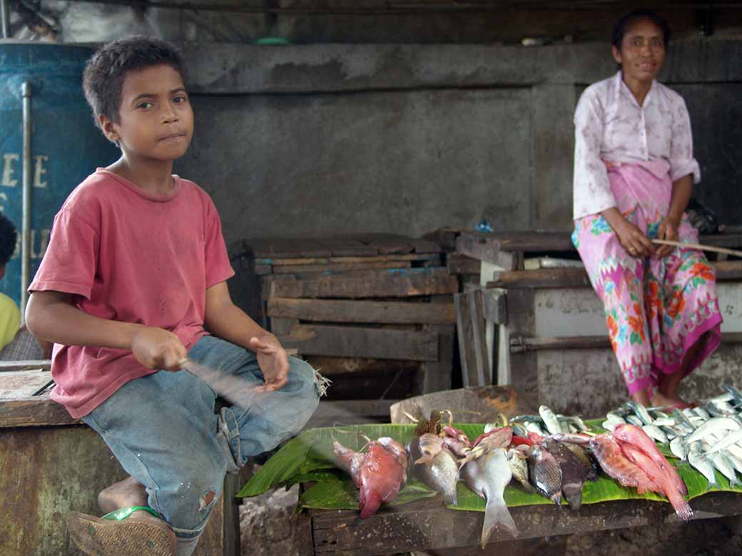 Boy selling fish