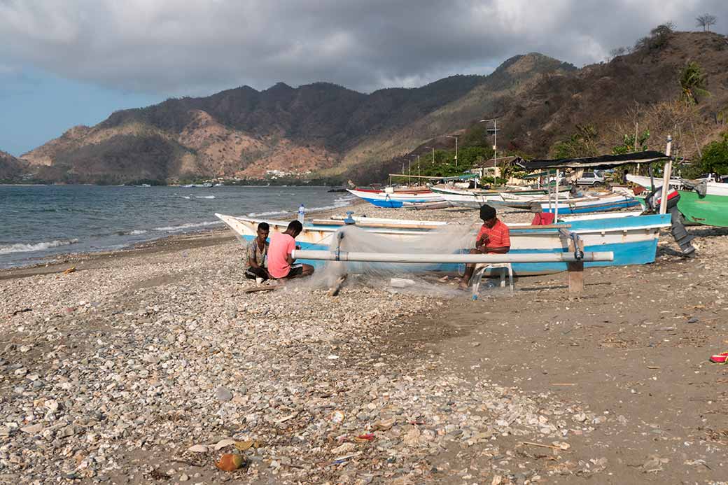 Men repairing their nets